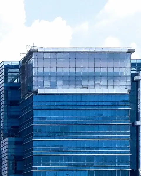 Glass office towers under a bright sky in Delhi NCR
